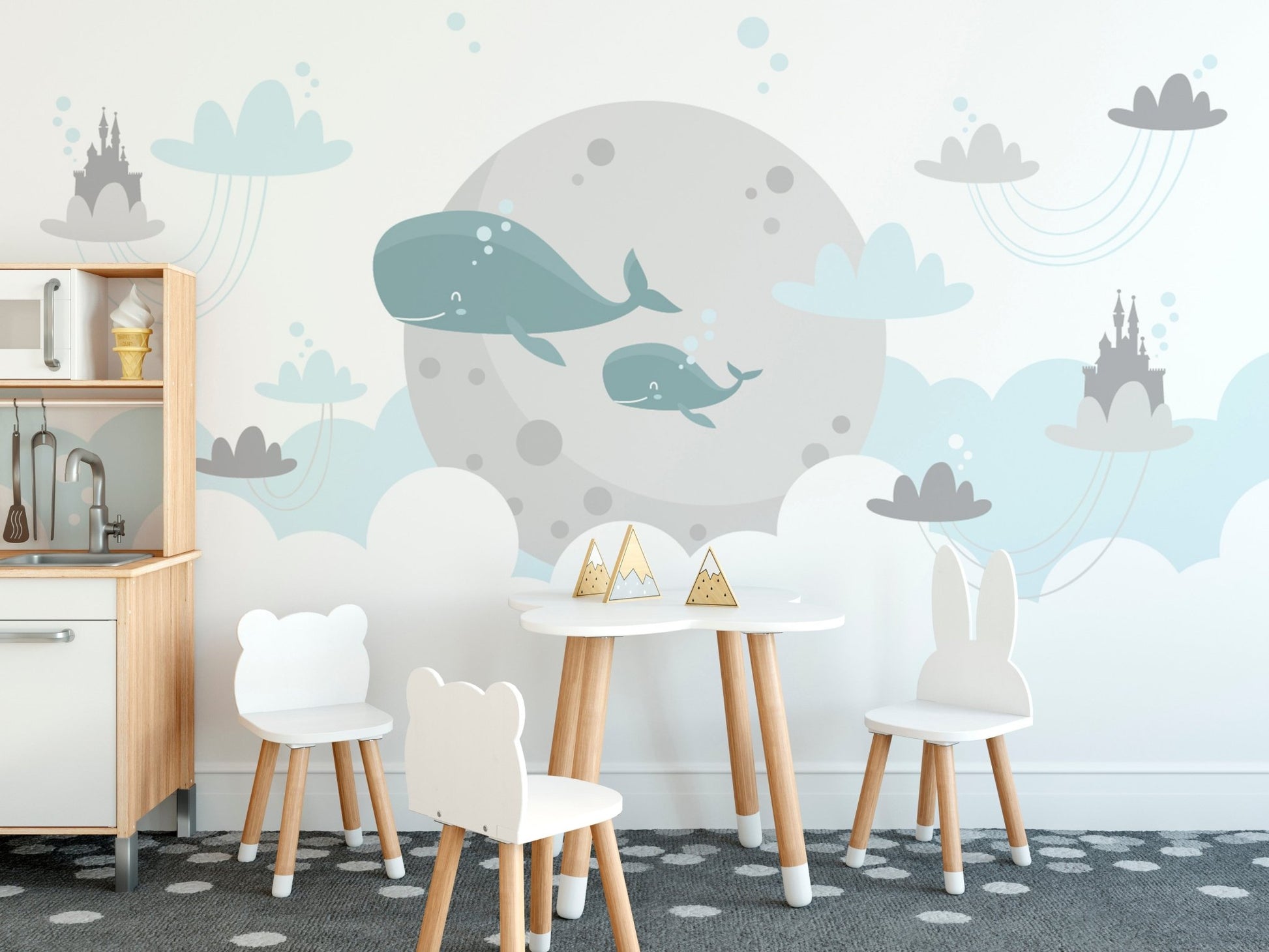 Child study area wall mural with white table, chairs, and grey whale design