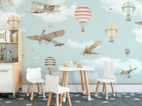 Scenic wall mural with planes and balloons in kids dining area.