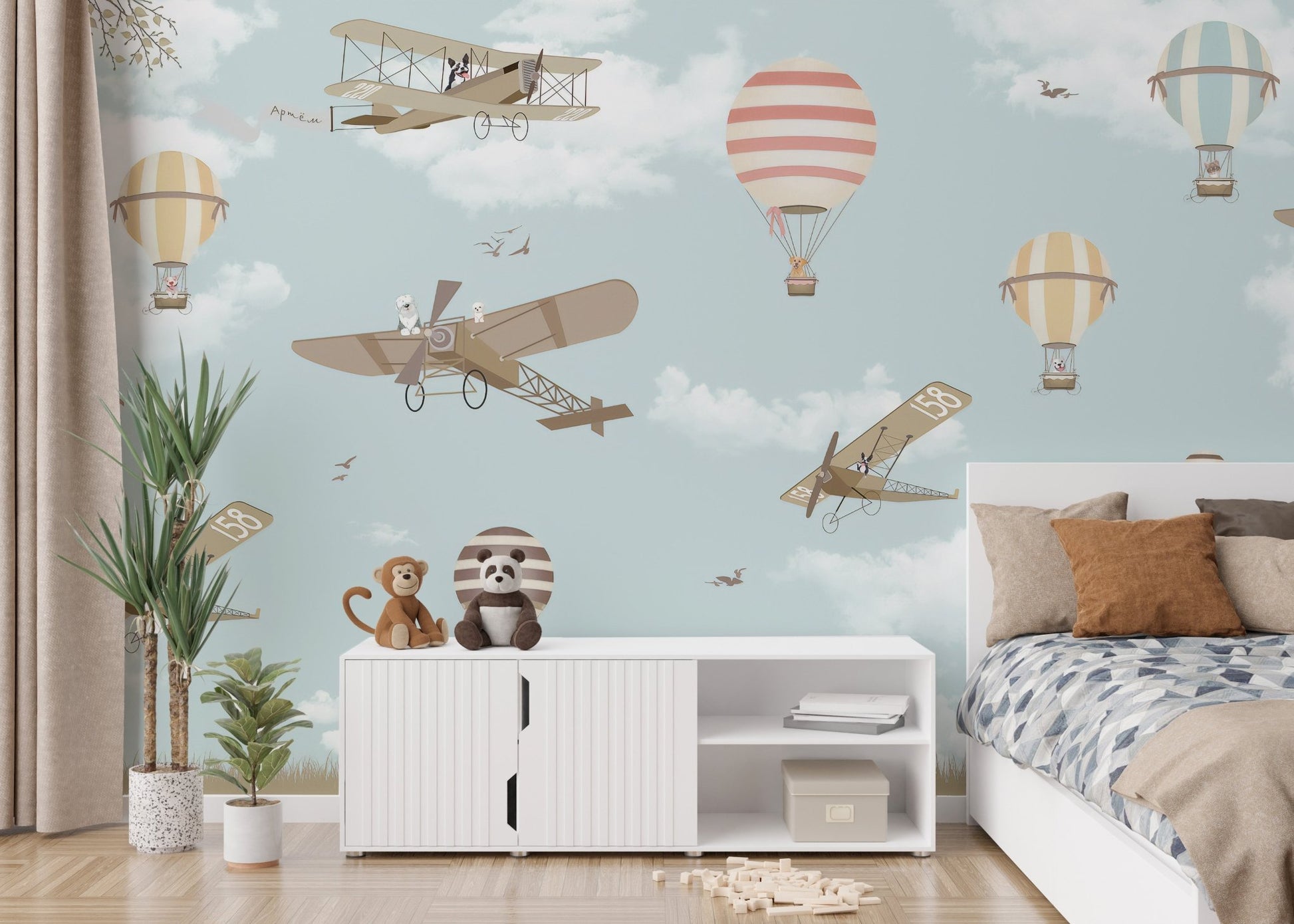 Sky-themed mural with planes and hot air balloons in kids bedroom.