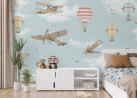 Sky-themed mural with planes and hot air balloons in kids bedroom.