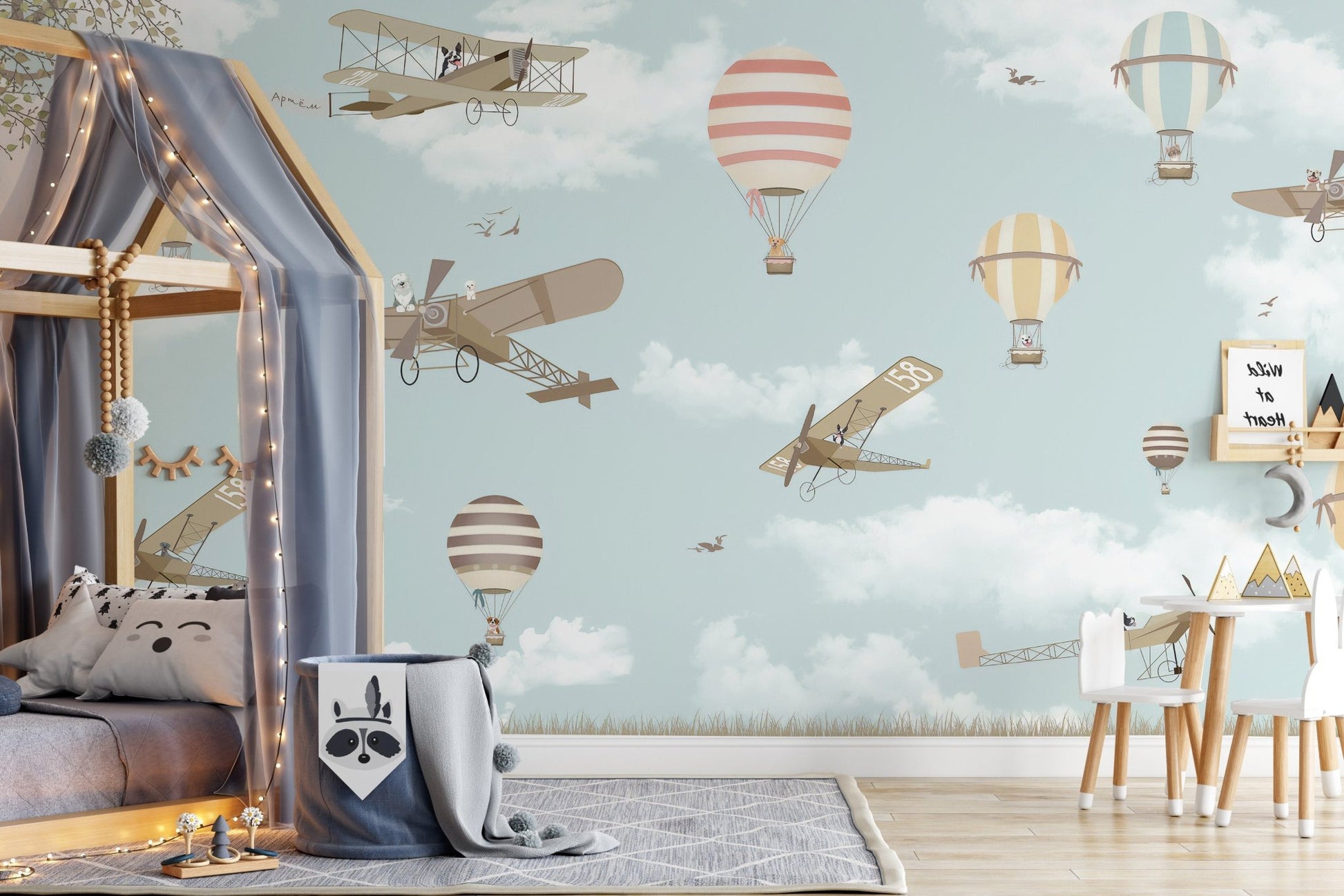 Whimsical hot air balloon mural with planes in toddler bedroom.