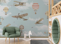 Airplane mural combined with floating balloons in nursery.