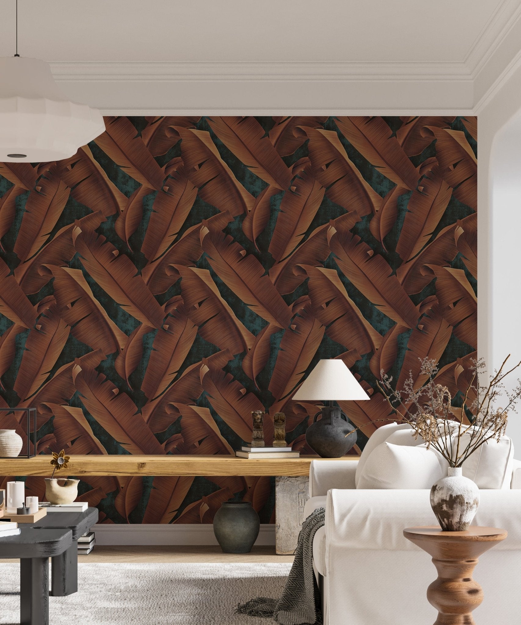 Autumnal leaf wallpaper in a living space with a white sofa and lamp.