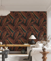 Autumnal leaf wallpaper in a living space with a white sofa and lamp.