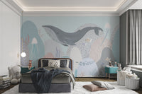 Whale swimming mural with soft ocean tones in kids bedroom.