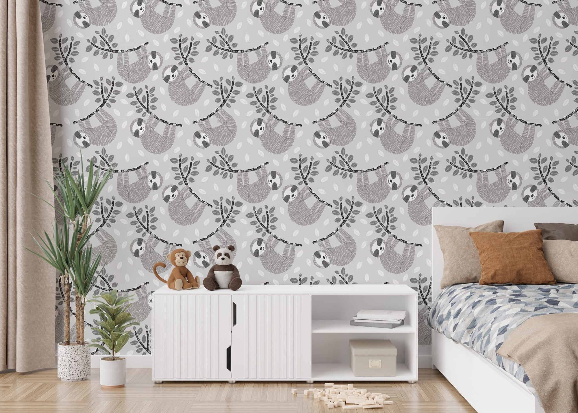 Grey sloth and leafy branches wallpaper in a bright kids bedroom with a white bed.