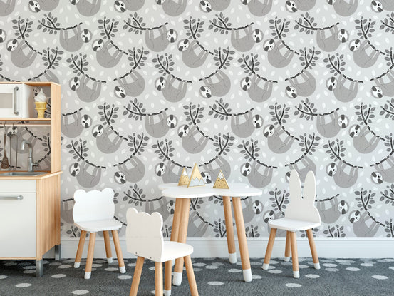 Activity room for children with sloth print wallpaper and a small table set.