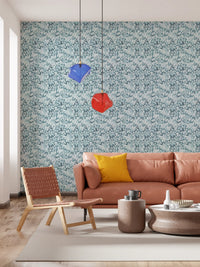 Modern living area with blue botanical wallpaper.