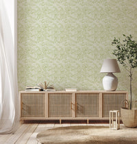 Living room corner with delicate green foliage wallpaper.