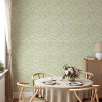 Green nature-inspired wallpaper in dining room.