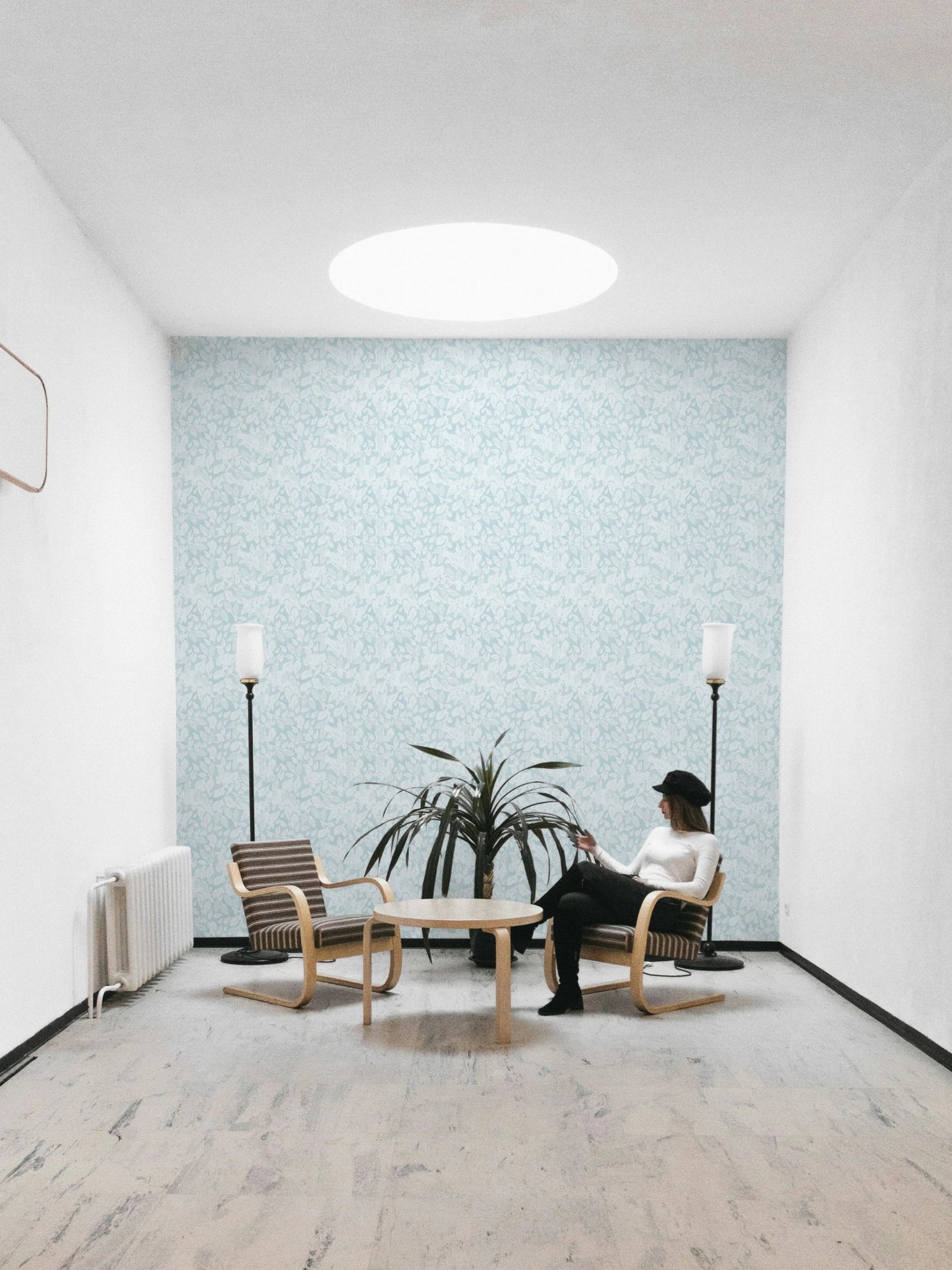 Leaves In Deep Sky Blue Wallpaper in a minimalist sitting room.