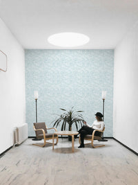 Leaves In Deep Sky Blue Wallpaper in a minimalist sitting room.