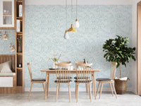 Sky blue leaf pattern wallpaper in a dining area.