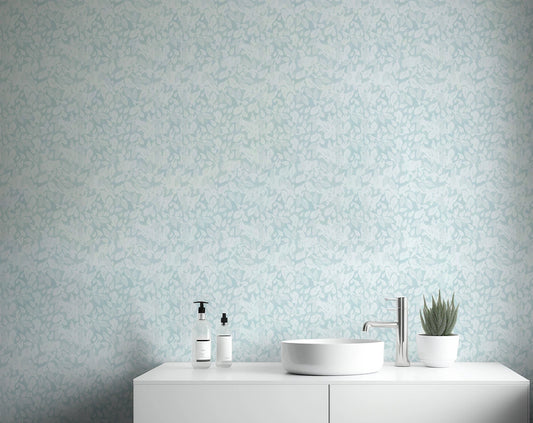 Leaves In Deep Sky Blue Wallpaper behind a white bathroom.