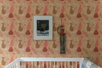 Nursery room featuring a vintage pitcher and botanical leaf wallpaper.