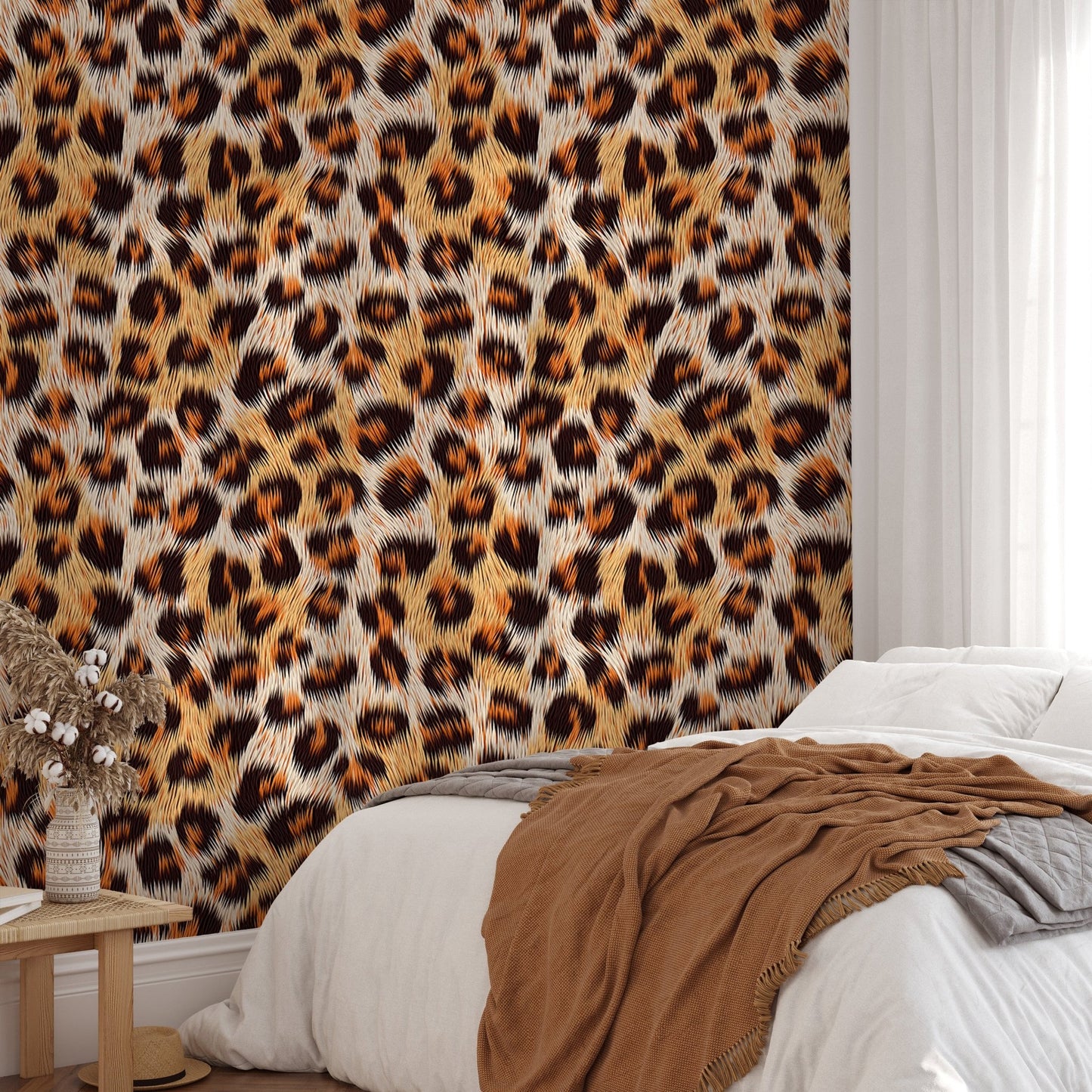 Leopard pattern wallpaper in a bedroom behind a bed with brown linen sheets.
