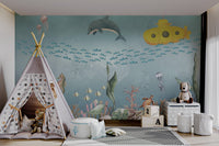 Yellow submarine traveling through fish  in a whimsical ocean-themed mural.
