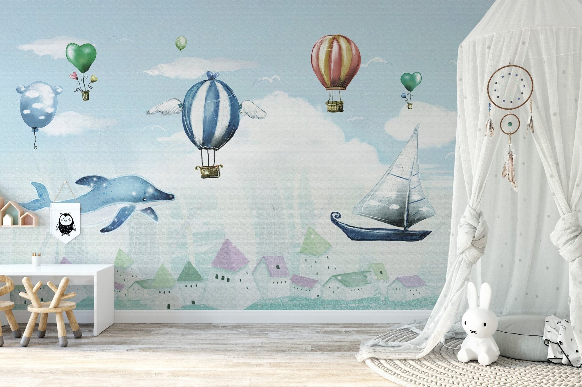 Whale and hot air balloon wall mural in a child’s play area.
