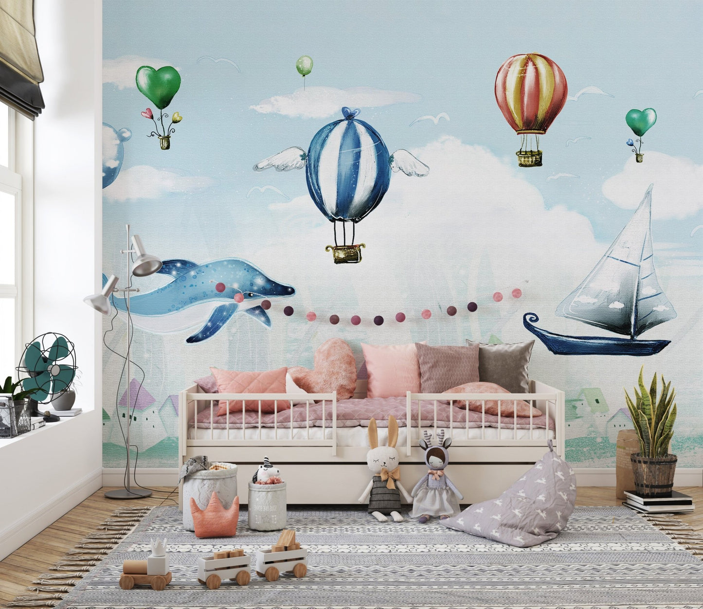 Floating whale and balloon wall mural in a minimalist kids room.