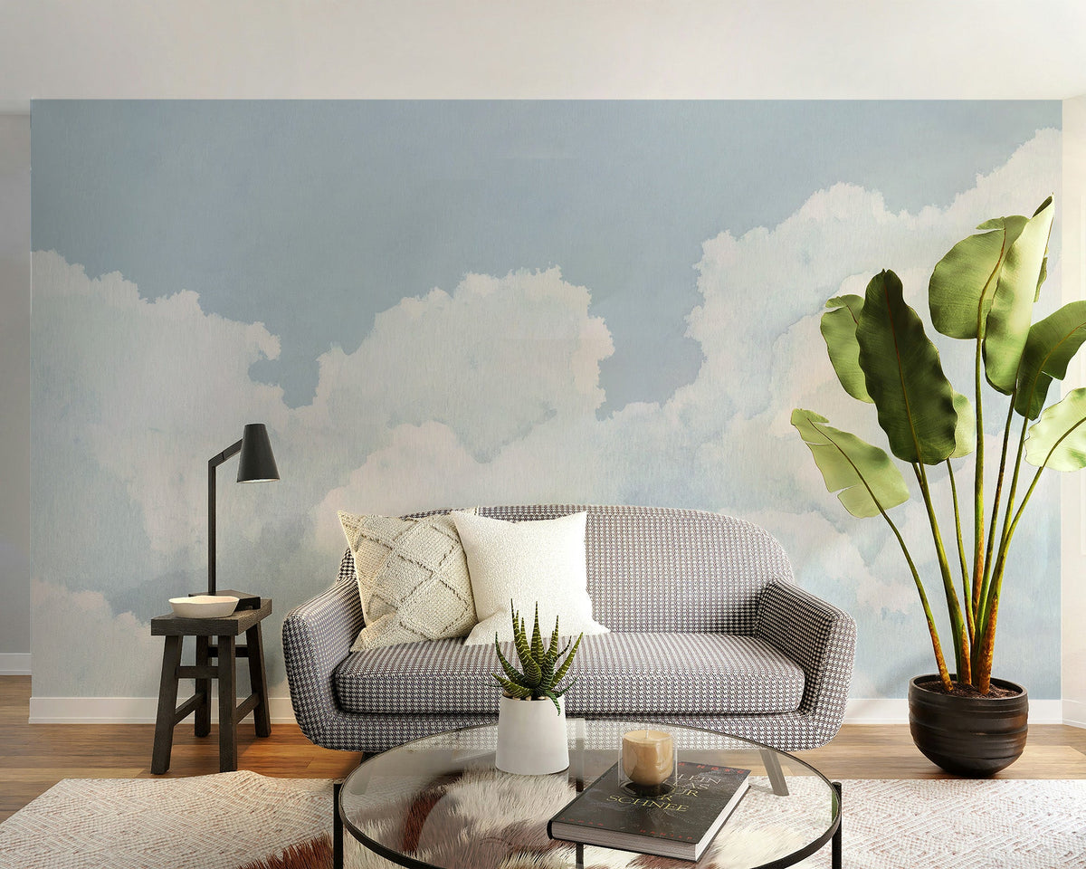 Light blue cloudy sky wallpaper with soft watercolor clouds and airy blue tones.