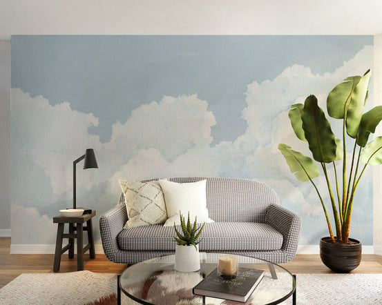 Light blue cloudy sky wallpaper with soft watercolor clouds and airy blue tones.