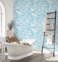 Light Blue Pattern Stormy Waves and Whales Wallpaper in a bathroom with a white tub.