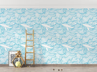 Blue stormy waves wallpaper in a playroom with a wooden ladder and toys.