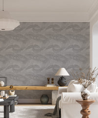 Contemporary living area with neutral tones and gray palm leaf wallpaper.