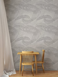 Minimalist dining space with wooden table and gray palm leaf wallpaper.