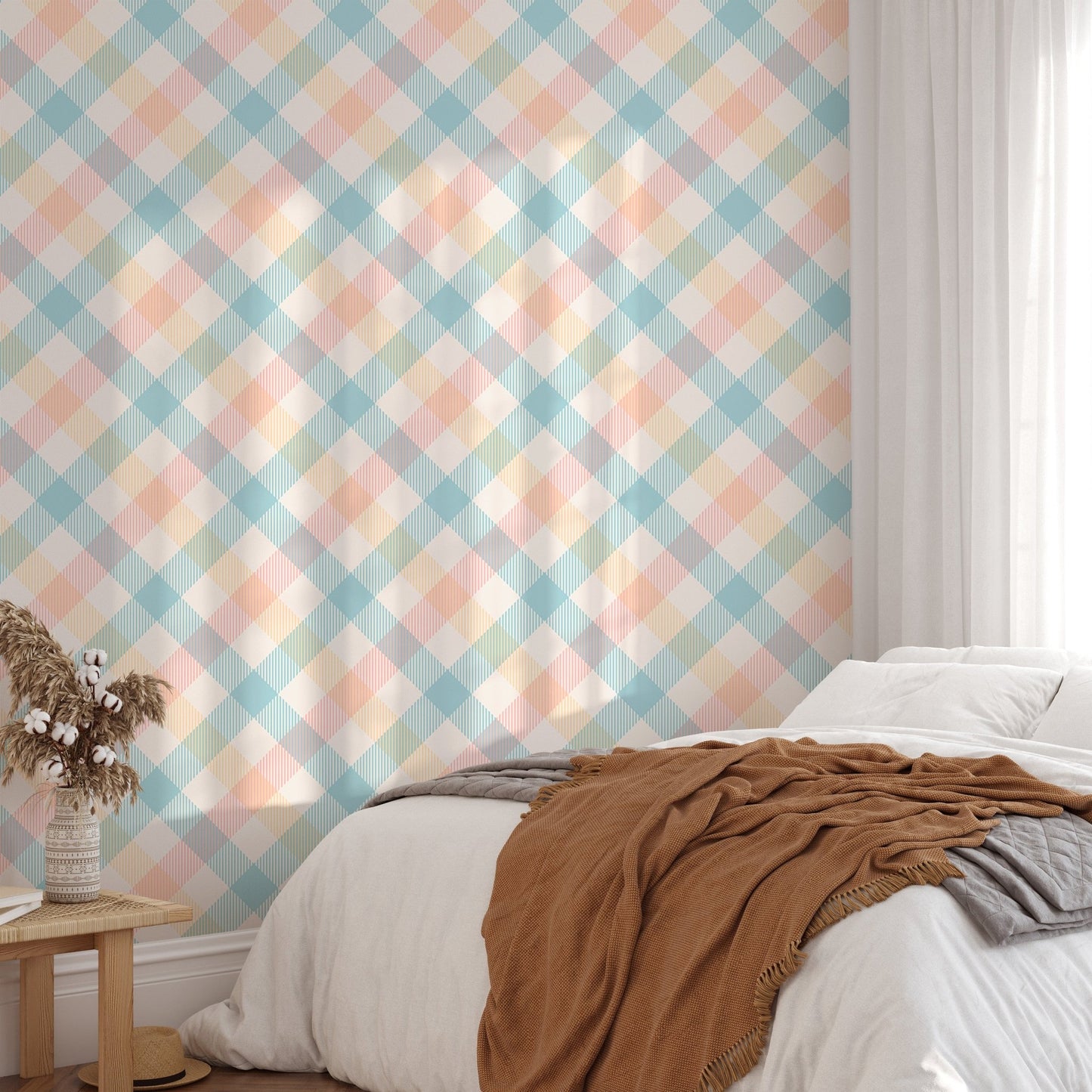 Sunlight hitting a bed with peach and blue geometric stripe wallpaper in the background.