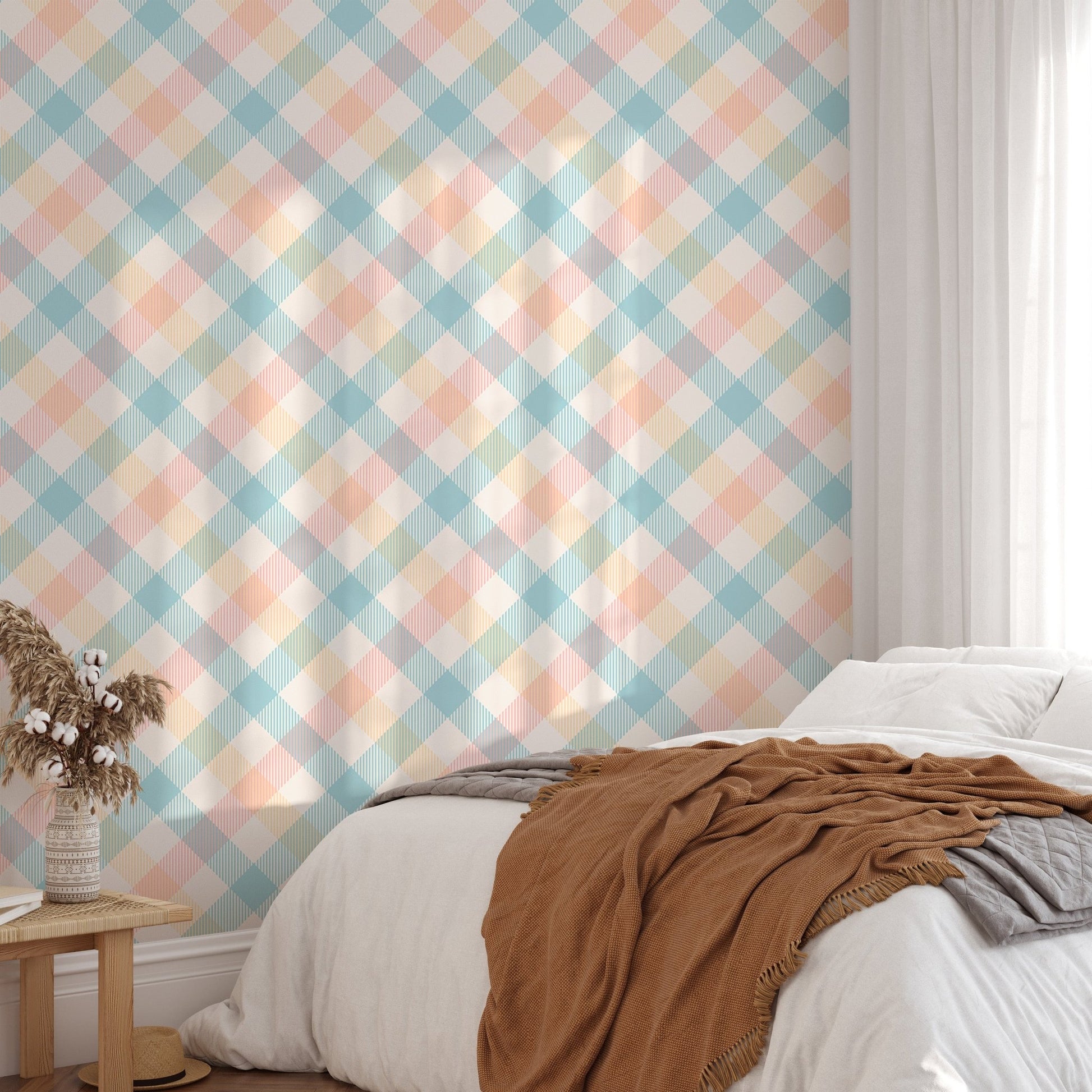 Sunlight hitting a bed with peach and blue geometric stripe wallpaper in the background.