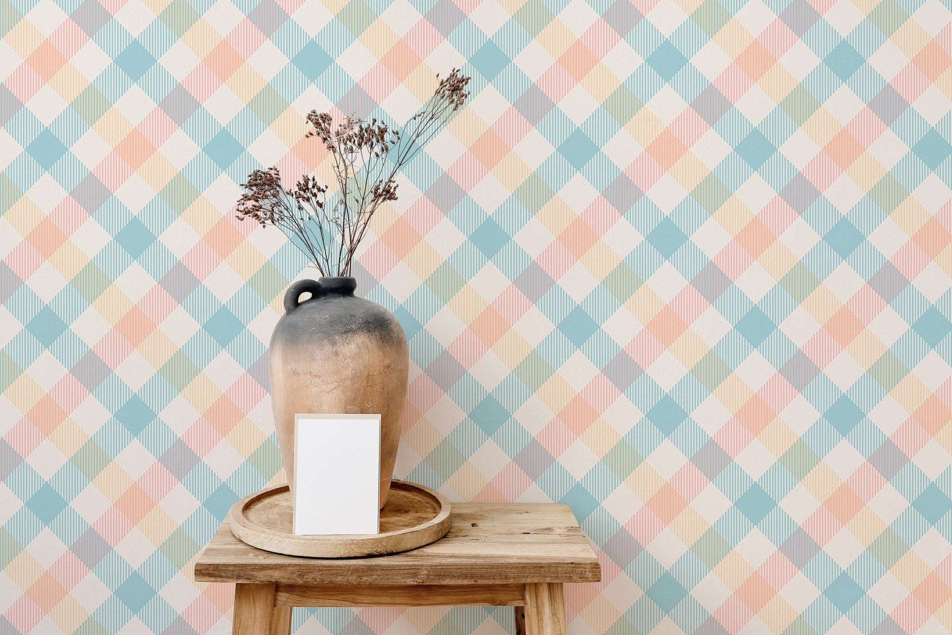 Decorative vase on a wooden stool against pastel geometric stripe wallpaper.