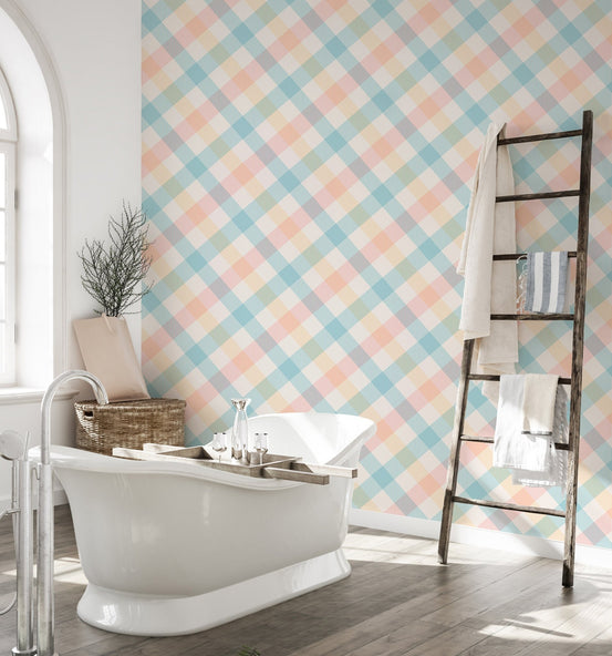 Bathroom with a white freestanding tub and pastel geometric stripe wallpaper.