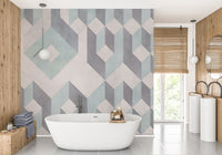 White freestanding bathtub against a grey and green linear wall mural.