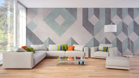 White sectional sofa in a bright lounge with a green and grey linear wall mural.