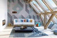Attic living space with a white sofa and a large geometric patterned wall mural.