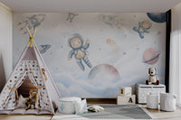 A dreamy outer space mural featuring colorful planets in child's playroom.