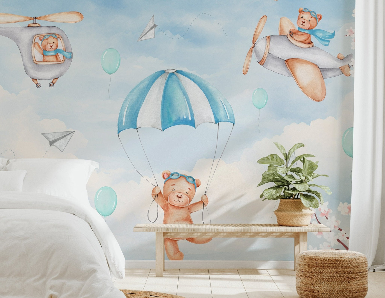 Blue sky mural with teddy bear flying a vintage airplane and paper planes.