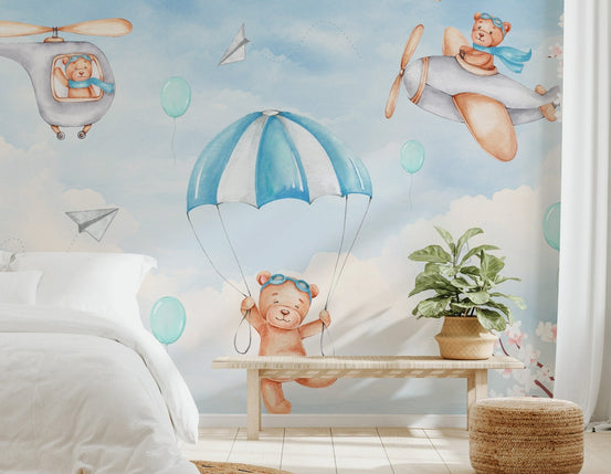 Blue sky mural with teddy bear flying a vintage airplane and paper planes.