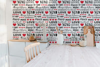 Seamless romance typography wallpaper with bold red heart accents.