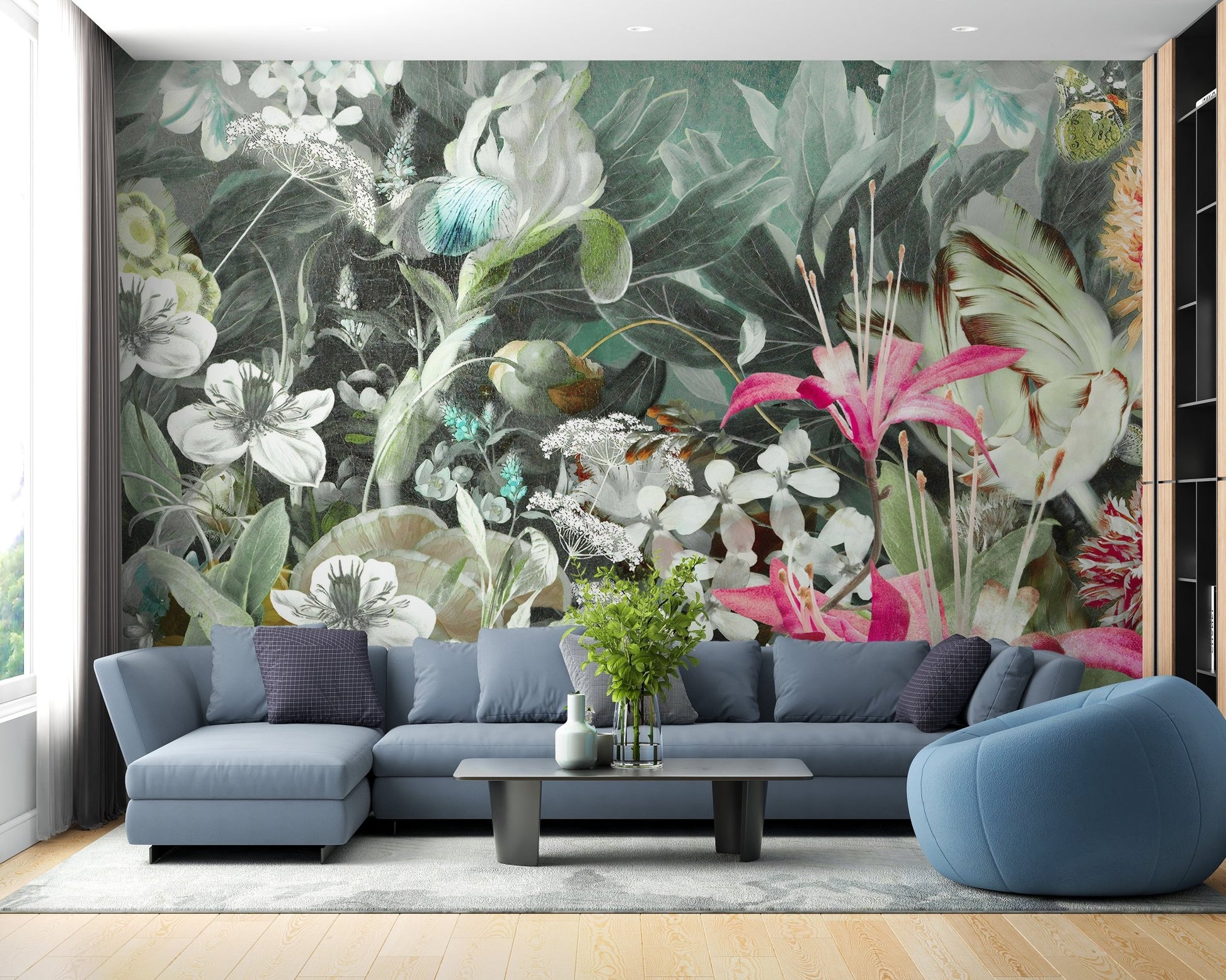 Blue modern sofa in apartment living space with large floral wall mural.