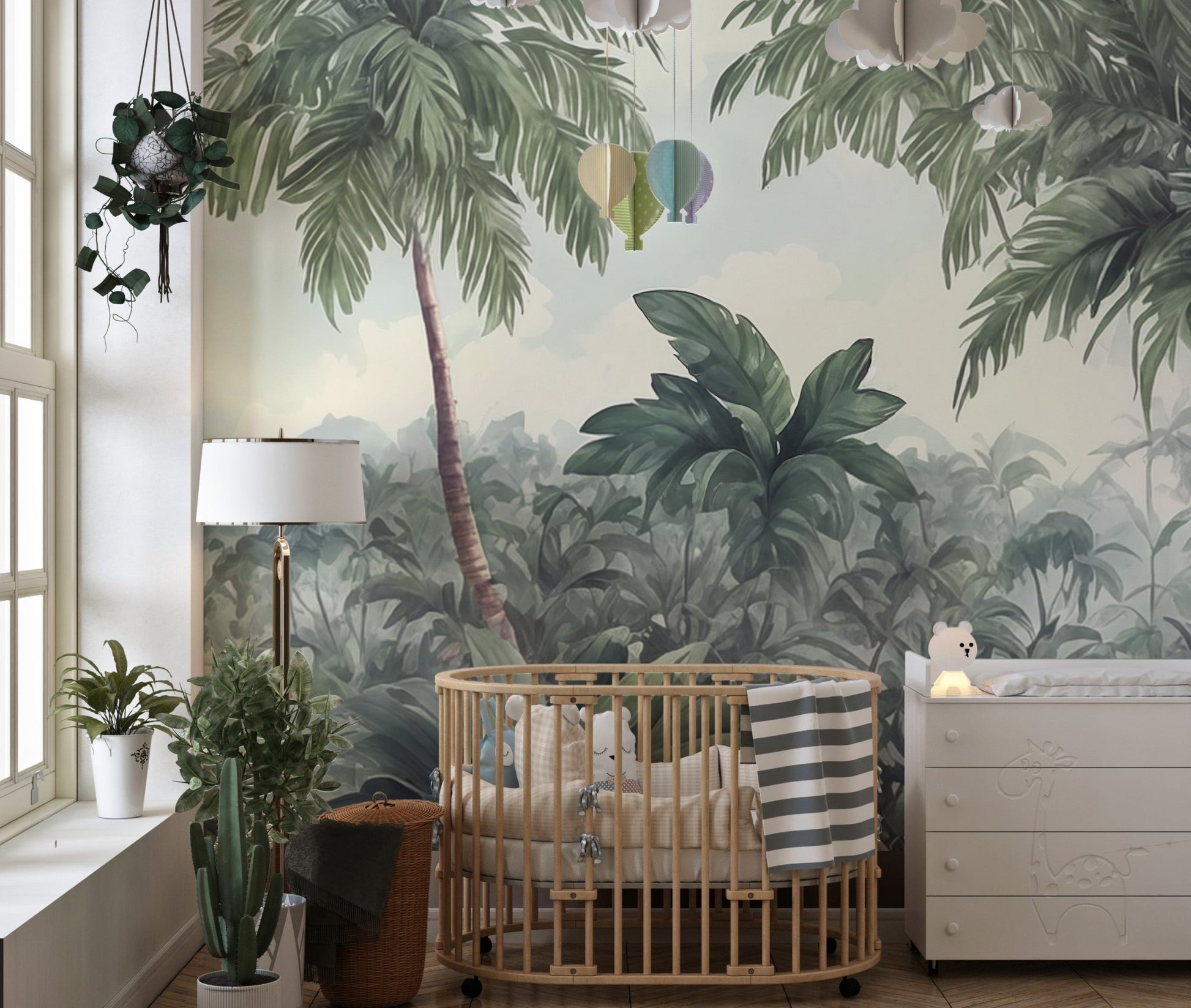 Lush palm tree wall mural in nursery with wooden crib and white dresser.