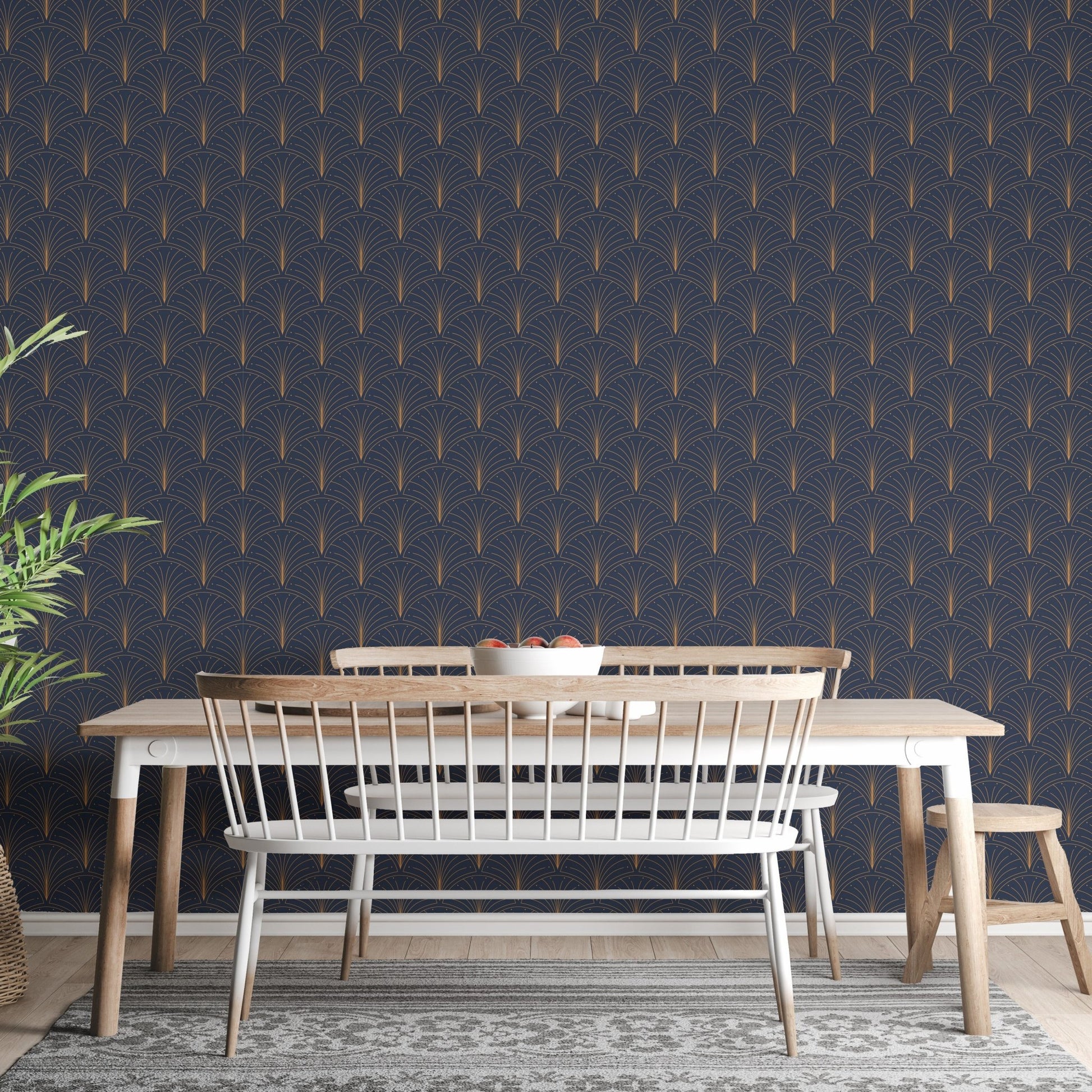 Wooden dining table set against a navy blue Art Deco wallpaper backdrop.