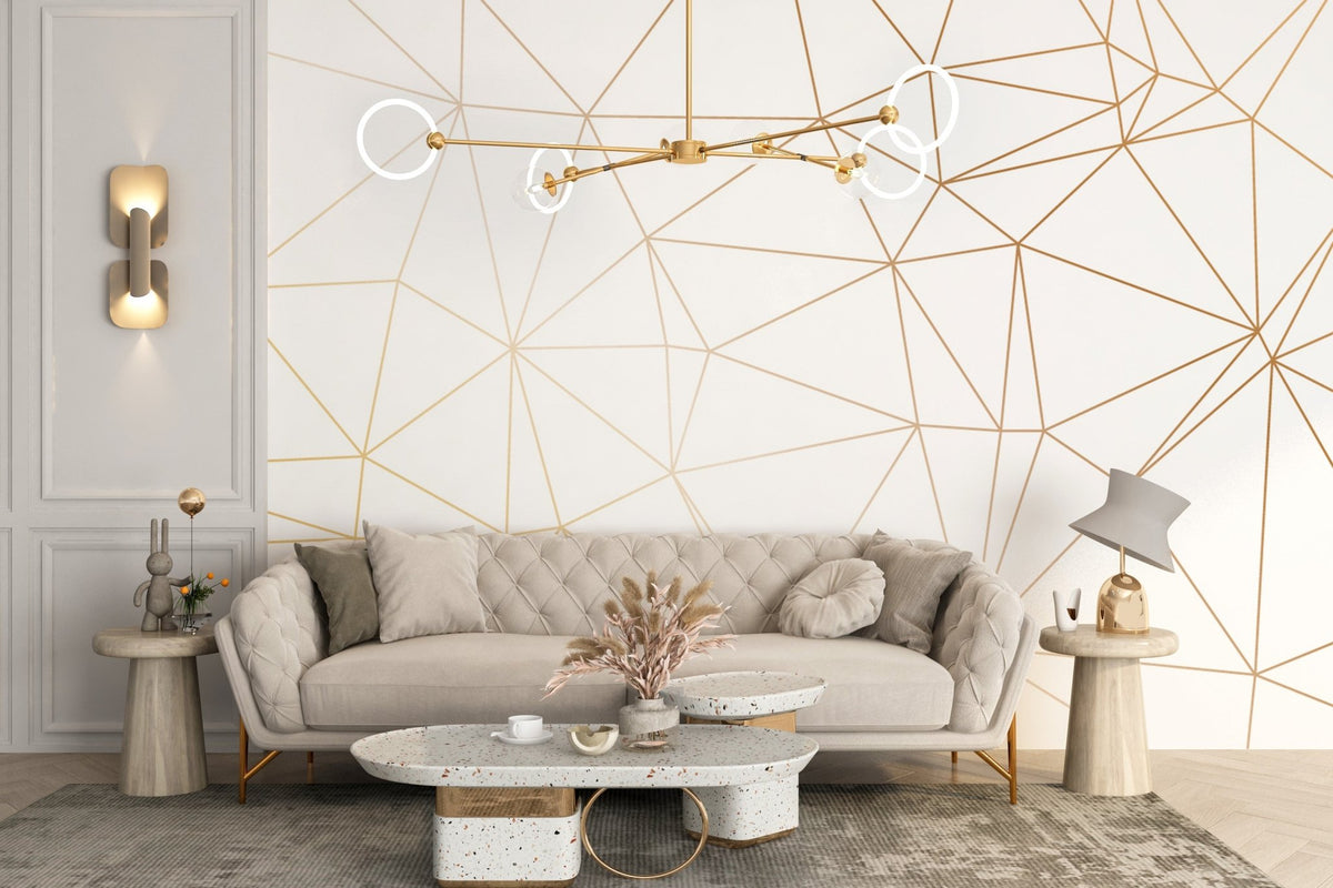 Neutral toned lounge with a tufted sofa and gold polygonal art wall mural.