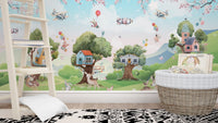 Activity room with light wood floors and a green jungle wall mural.