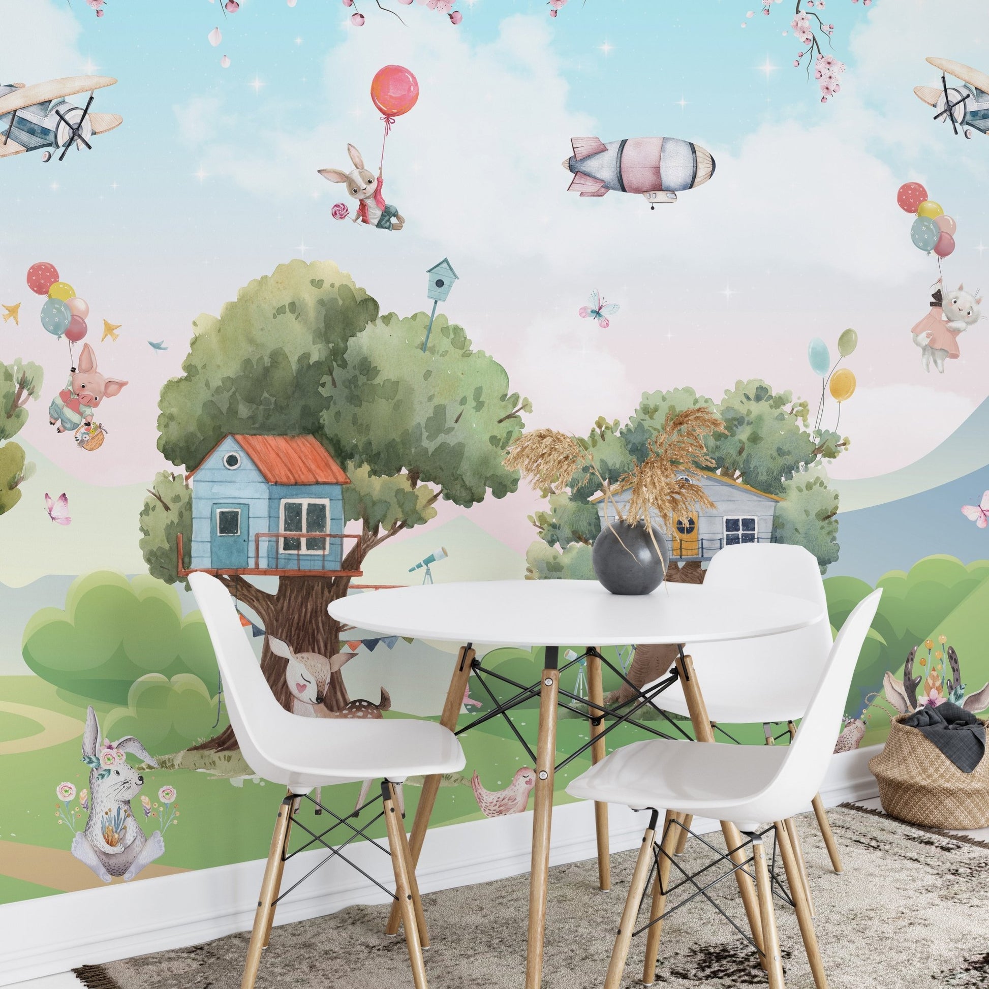 Dining area for children with white chairs and a jungle animal wall mural.