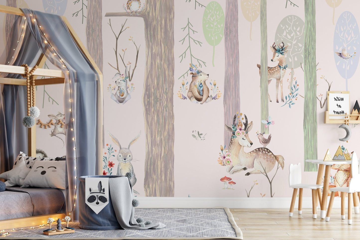 Playful woodland animal wall mural behind a grey canopy bed and wooden toys.