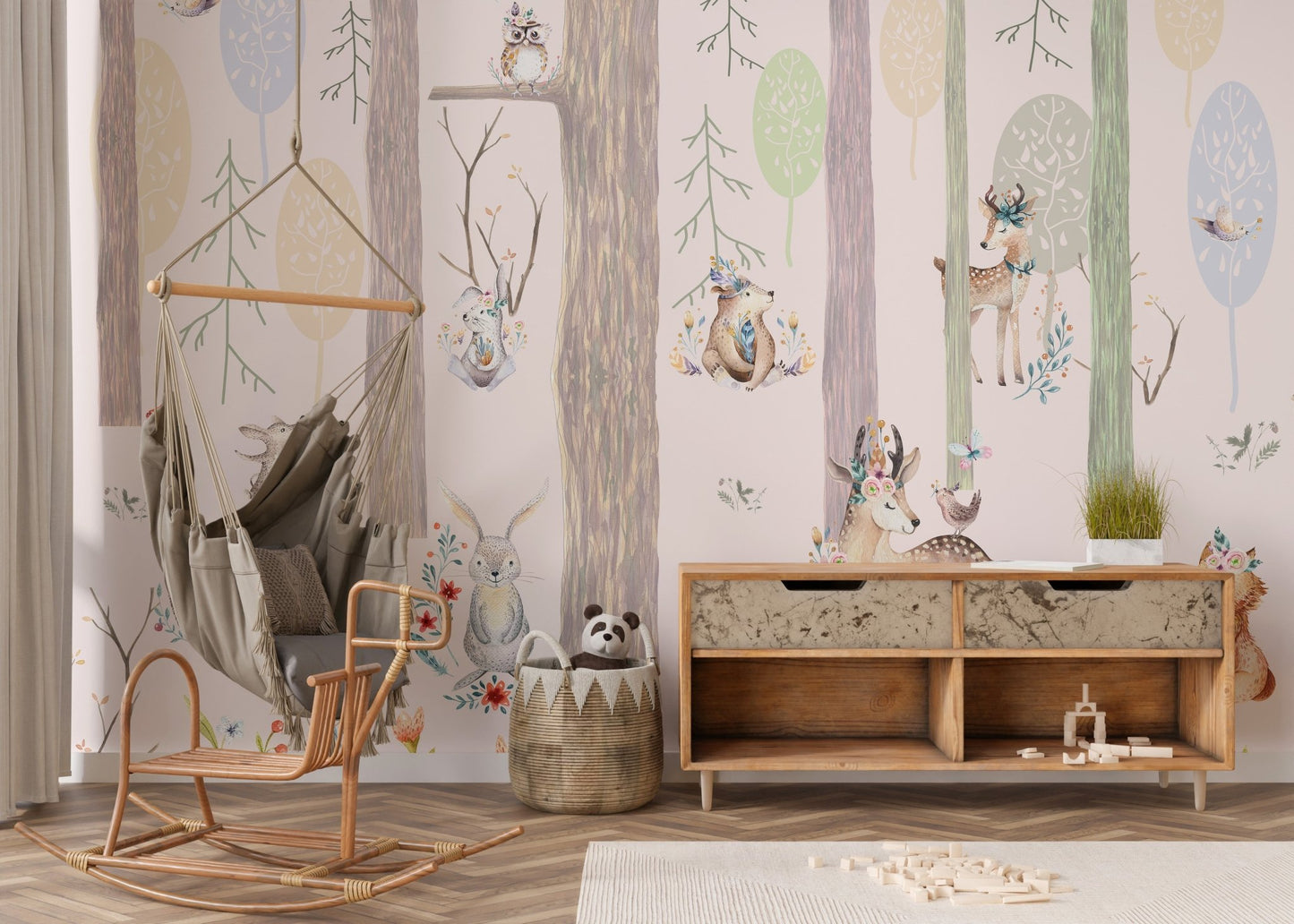 Forest wall mural featuring foxes and squirrels behind a wooden toy chest in nursery.