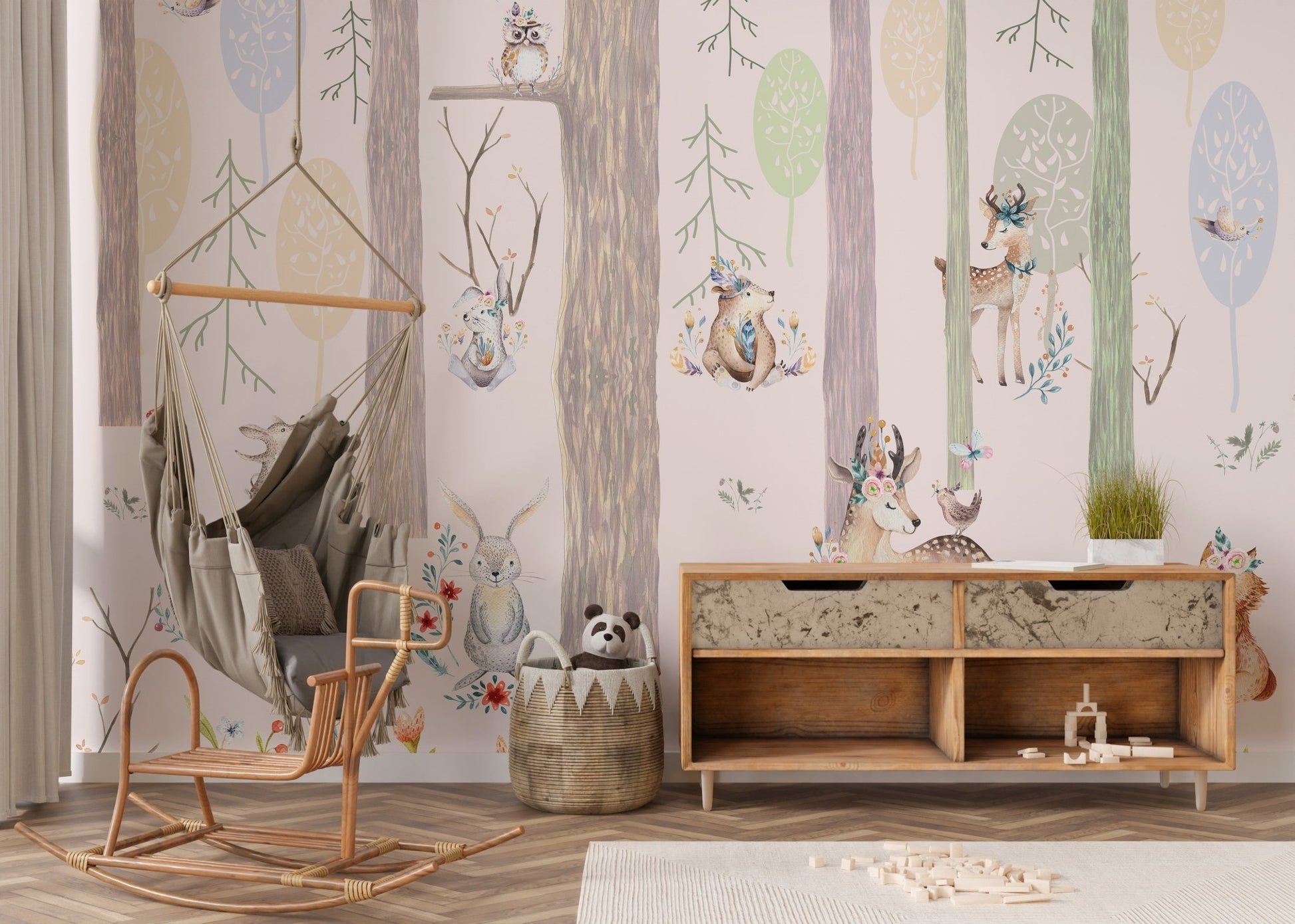 Forest wall mural featuring foxes and squirrels behind a wooden toy chest in nursery.