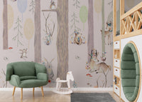 Green armchair placed against a neutral forest themed wall mural with animal motifs.